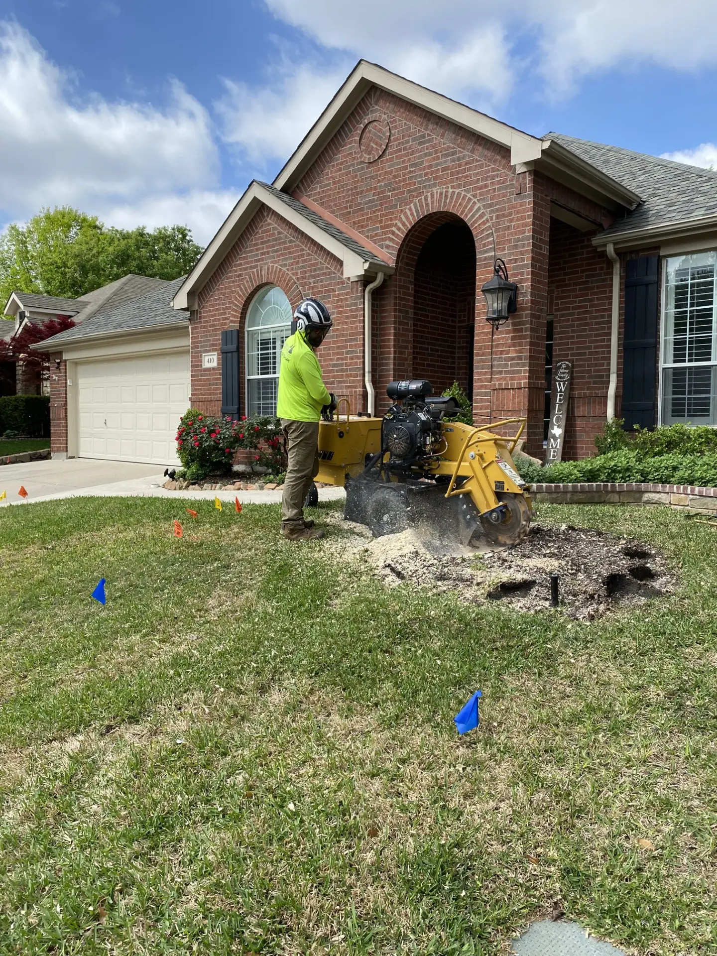 Tree MD's crew member operating a stump grinder at a residential property in McKinney, Texas